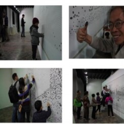 The local people in Foshan participate in the public art project by leaving their fingerprints on the canvas.佛山市民在画布上印上指纹