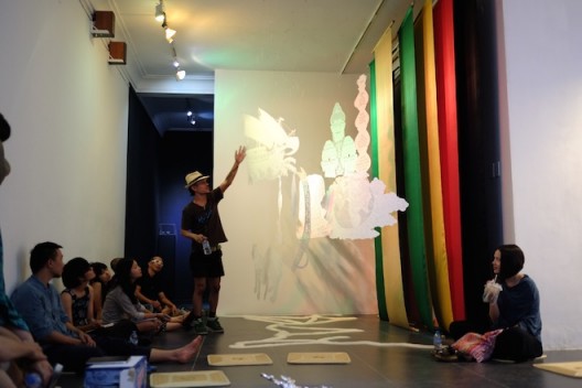 ‘Session 5: Sàn Art Laboratory’ in group critique mode with Indonesian artist Rudy Atjeh explaining his work on view at San Art; November 2014 (image courtesy of Sàn Art)