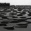 杨牧石，《消磨》，木料，铝板和黑色喷漆，55 × 510 × 780 cm，2013-2016. Yang Mushi, "Grinding", wood, aluminum plate and black spray lacquer, 55 x 510 x 780 cm, 2013-2016