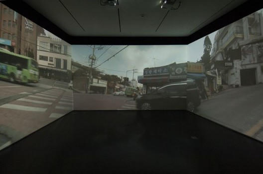Passage/s: The Pram Project, 2015, three-channel video, dimensions variable. Installation view, Contemporary Arts Center Cincinnati. Photo by Tony Walsh. Courtesy the artist, Lehmann Maupin, New York and Hong Kong, and Contemporary Arts Center Cincinnati.