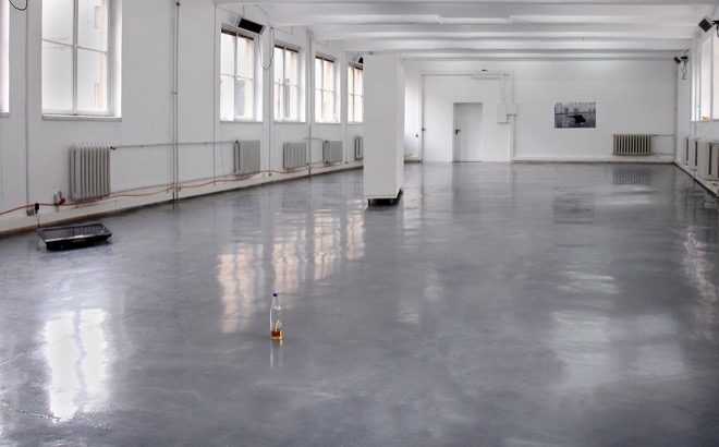 Installation view: Monitor, HD video, sound, 6:54 min.: Featuring dancer / actor Búi Rouch Wooden wall on wheels (315 x 210 x 50 cm) Laser print on paper (84,1 x 118,9 cm): Documentation of performance Club-Mate bottles Hand blown glass (various dimensions)
