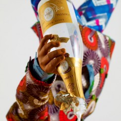 Yinka Shonibare MBE, Champagne Kid 7, unique life-size mannequin, Dutch wax printed cotton textile, leather, resin, chair, globe and Cristal champagne bottle, 178 x 85 x 76cmcm, 2013