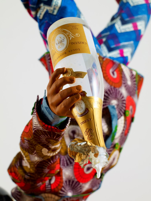 Yinka Shonibare MBE, Champagne Kid 7, unique life-size mannequin, Dutch wax printed cotton textile, leather, resin, chair, globe and Cristal champagne bottle, 178 x 85 x 76cmcm, 2013