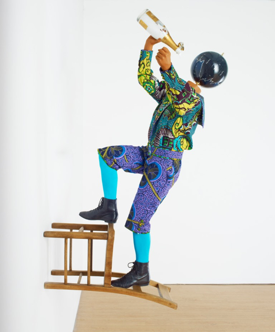 Yinka Shonibare MBE, Champagne Kid 8, unique life-size mannequin, Dutch wax printed cotton textile, leather, resin, chair, globe and Cristal champagne bottle, 178 x 85 x 76cmcm, 2013