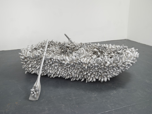 Yayoi Kusama, “Walking on the Sea of Death,” sewn stuffed fabric, fiberglass rowboat, silver paint, 58 x 256 x 158 cm, 1981.