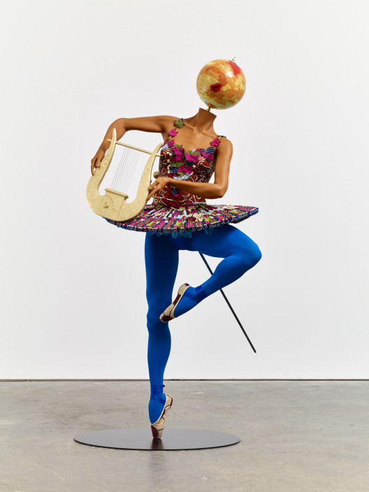 Yinka Shonibare, “Ballet God (Apollo)”, fibreglass mannequin, Dutch wax printed cotton textile, lyre, sword, globe, pointe shoes and steel baseplate, 193 x 86 x 85 cm, 2015.